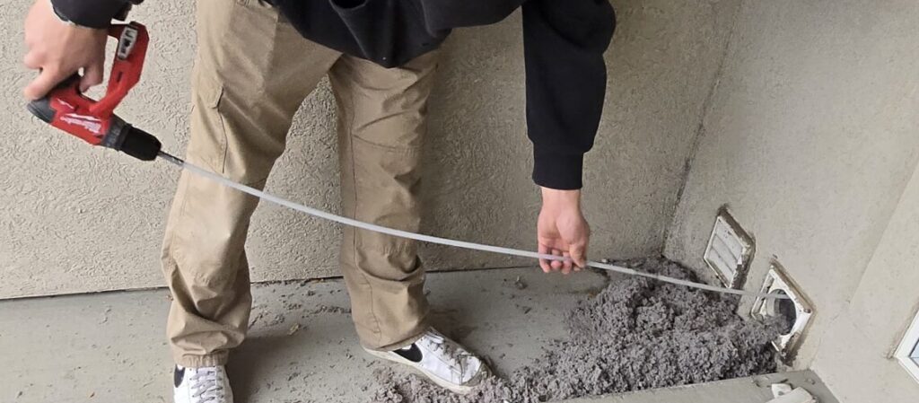 technician cleaning a dryer vent and removing lint buildup in boise, idaho, providing professional dryer vent cleaning services across the treasure valley including nampa, meridian, caldwell, and eagl...sorry but this string is too long !!!
