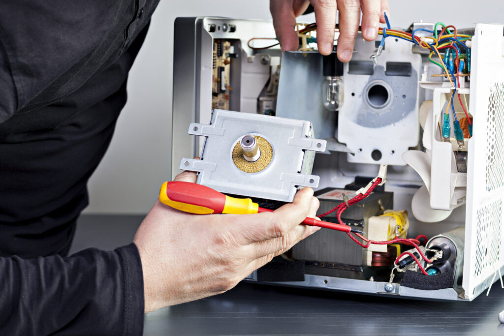 technician repairing internal microwave components in boise, idaho, providing reliable microwave repair services across the treasure valley including nampa, meridian, caldwell, and eagle