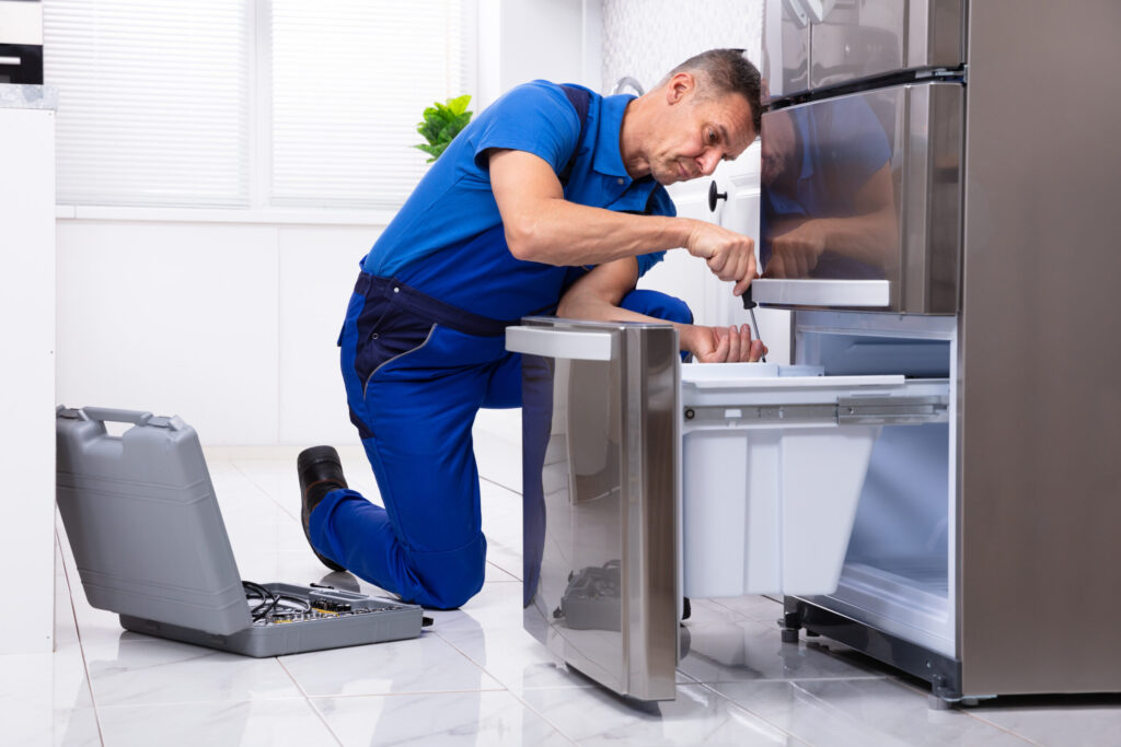 appliance repair technician fixing a refrigerator drawer in boise, idaho, providing professional refrigerator repair services across the treasure valley including nampa, meridian, caldwell, and eagle