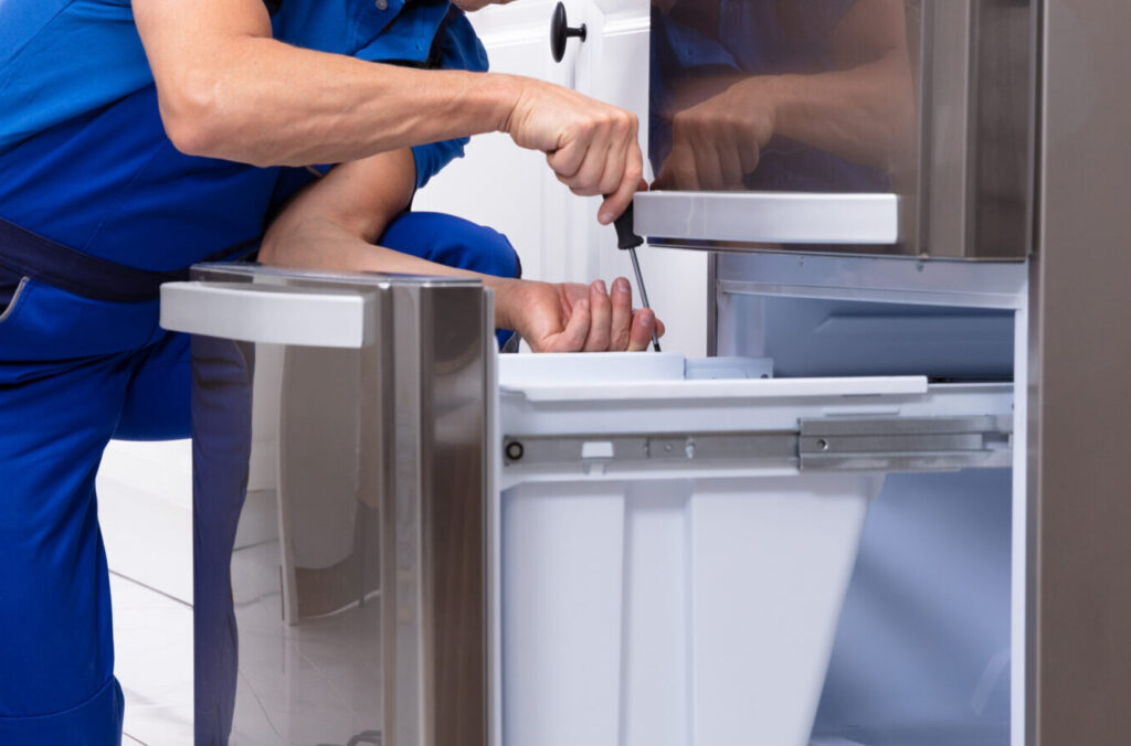 appliance repair technician fixing a refrigerator drawer in boise, idaho, providing professional refrigerator repair services across the treasure valley including nampa, meridian, caldwell, and eagle
